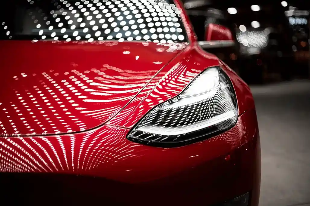Ceramic Coating Being Applied to Red Tesla Model Y in Bellevue
